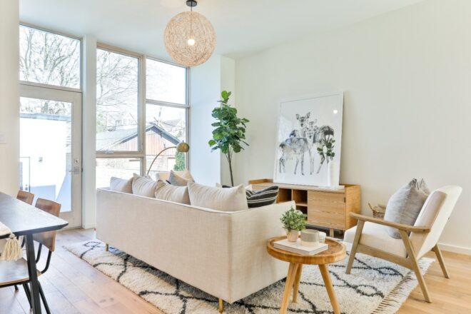 white sofa on printed rug facing black and white wall art