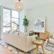 white sofa on printed rug facing black and white wall art