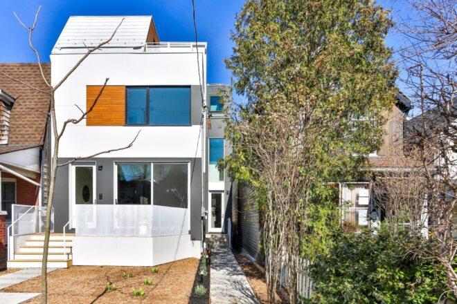 narrow, white three-story home