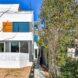 narrow, white three-story home