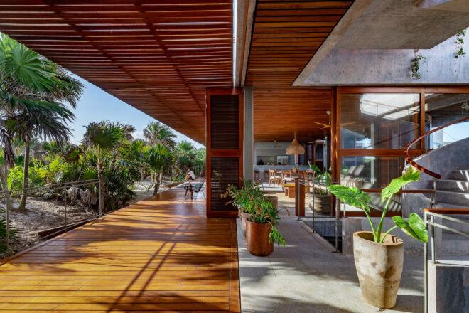 a deck with wood accents connected to the interior of a villa