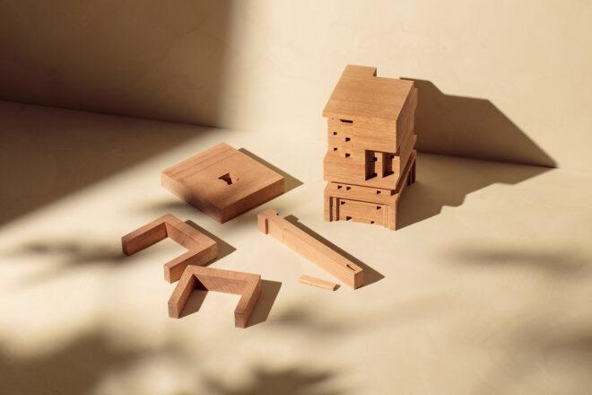 several different wood pieces beside a nearly finished beehive
