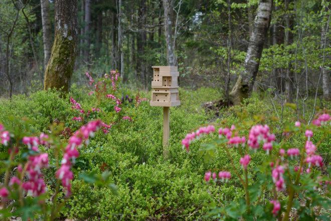 wood beehive on a stake in a meadow