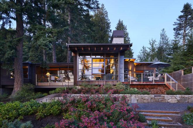 a single-story home with square structures and a front yard full of flowers