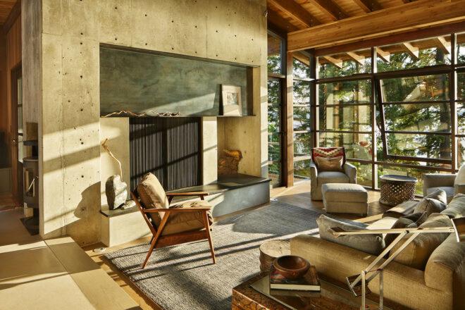 a living room with lgiht flowing in through floor-to-ceiling windows
