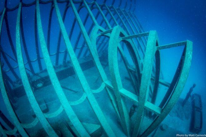 statue of curved entrance to an underwater greenhouse