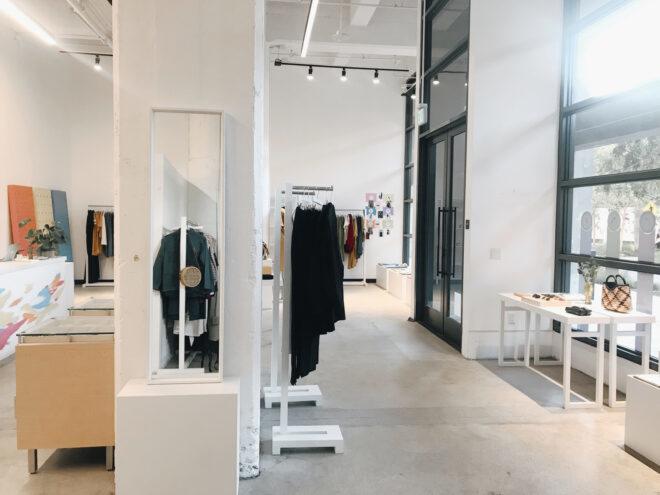 racks of neutral-colored clothing in a shop