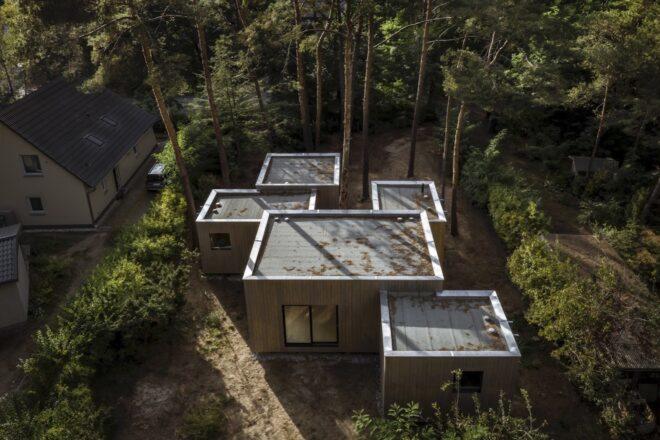aerial view of home with five cube volumes surrounded by trees