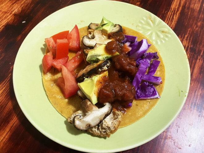 a vegan taco on a green plate