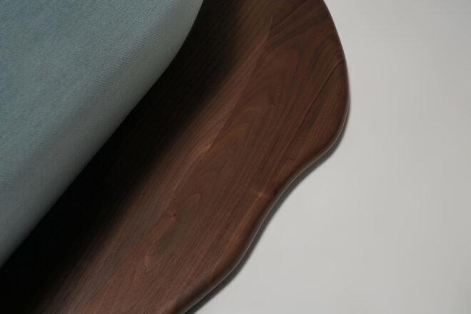 close-up of curvy dark wood base of a sofa