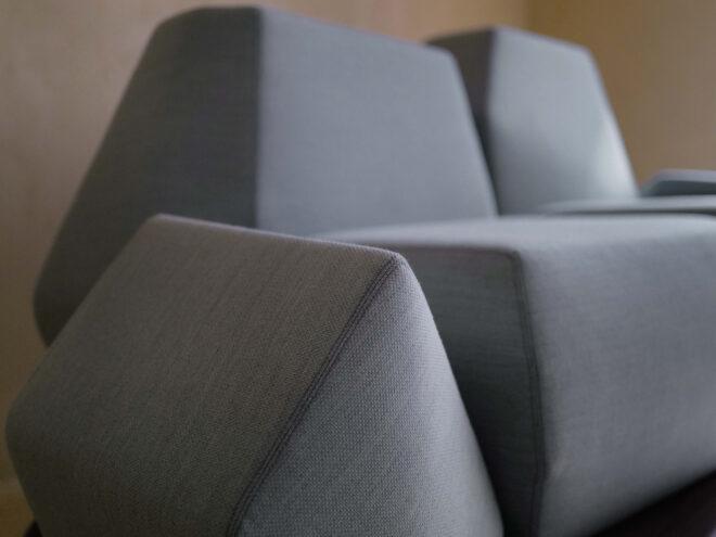 close-up of angular light blue arm of a sofa