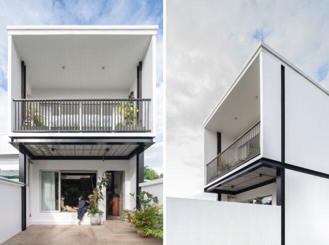 tall, two-story white home with a large balcony