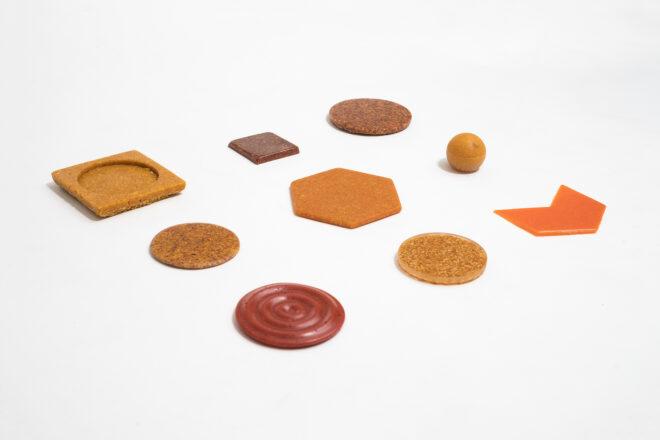 samples of recycled materials in the colors orange and red, lined up in a three-by-three grid