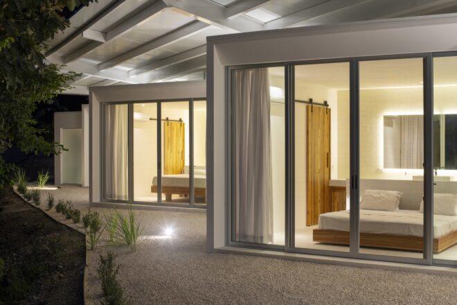 a view of the home from outside, highlighting the zigzag layout and windowed facade