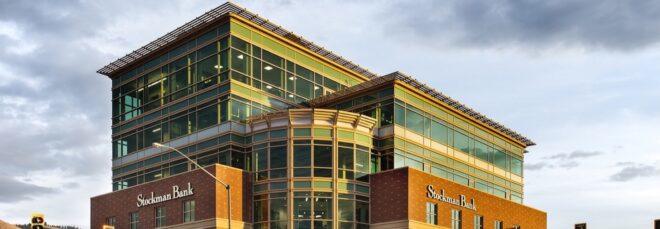 large brick and glass bank building on a street corner