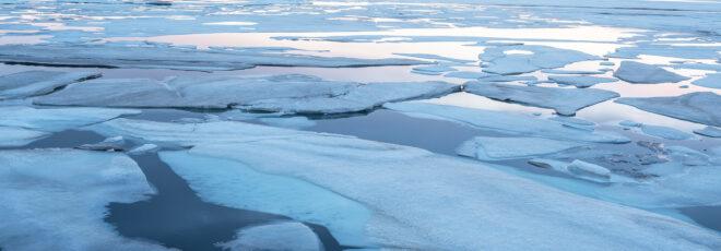 patchy ice on the surface of ocean water