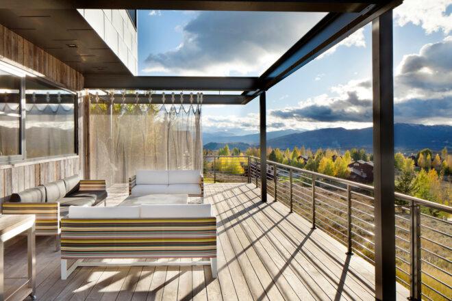 three white sofas on a wood deck