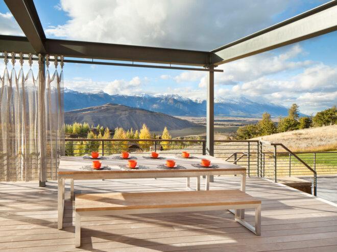 large wood table and benches on an open-air deck