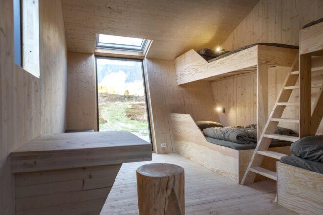 wood-lined room with built-in wood beds