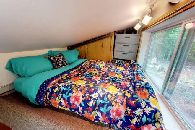 large bed with floral bedspread