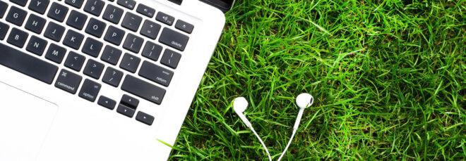 laptop and headphones in grass