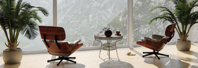 two chairs and two plants facing a glass window with mountainous views