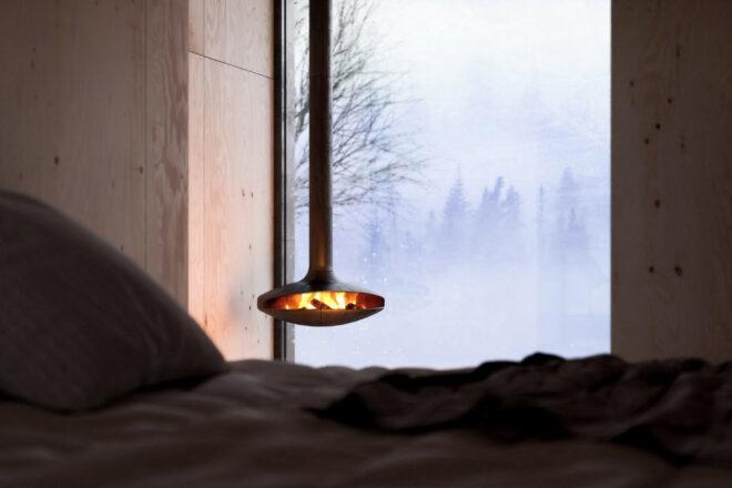 Bed near suspended fireplace