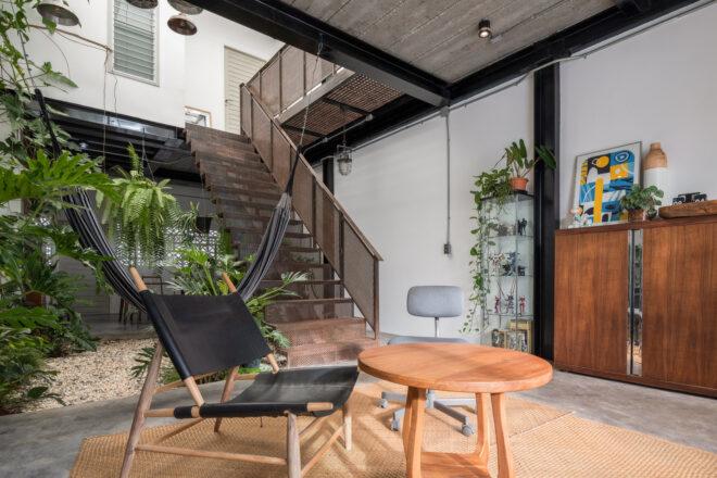 black chair and wood table in room near an indoor garden