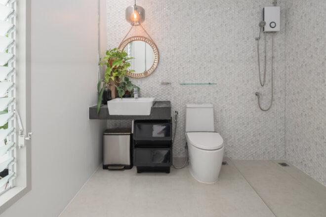 bright bathroom with white tiling and plants