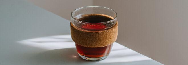glass coffee cup with cork exterior
