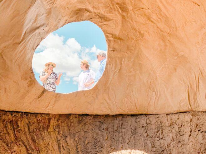 people looking into skylight of a dome home