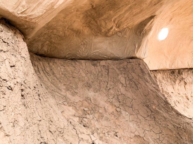 close-up of connected paper dome and excavated desert earth
