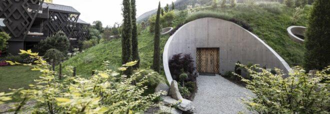 rounded building with a hilly green roof