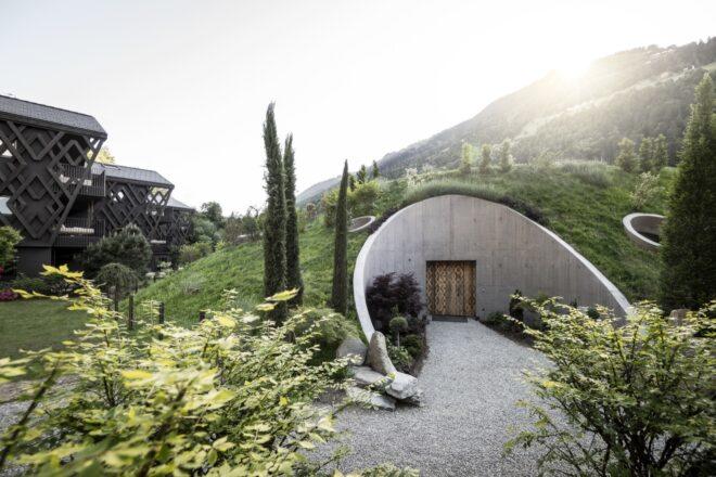 rounded building with a hilly green roof