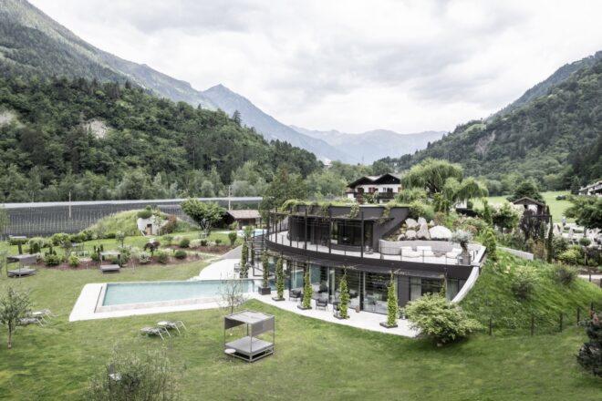 aerial view of black wellness center building with a green roof
