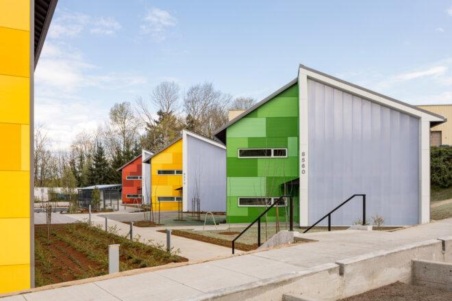 green, red and blue buildings with angled roofs