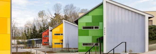 green, red and blue buildings with angled roofs