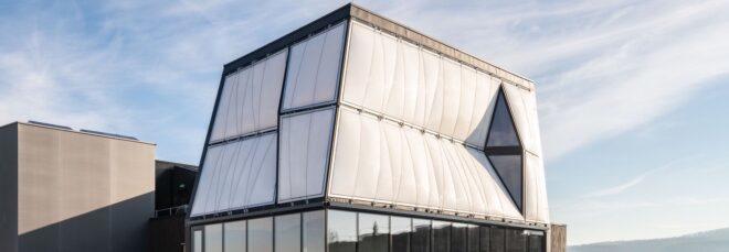 white and glass home on top of another building