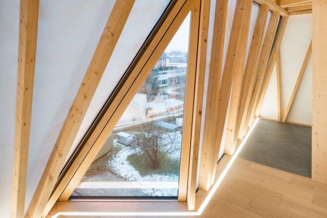 wood-beamed room with triangular window
