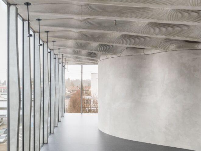 concrete room with wavy ceiling