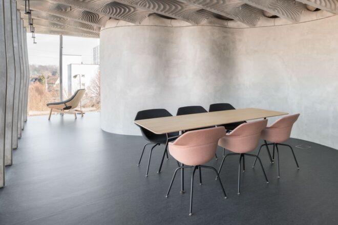 wood table with black and pink dining chairs