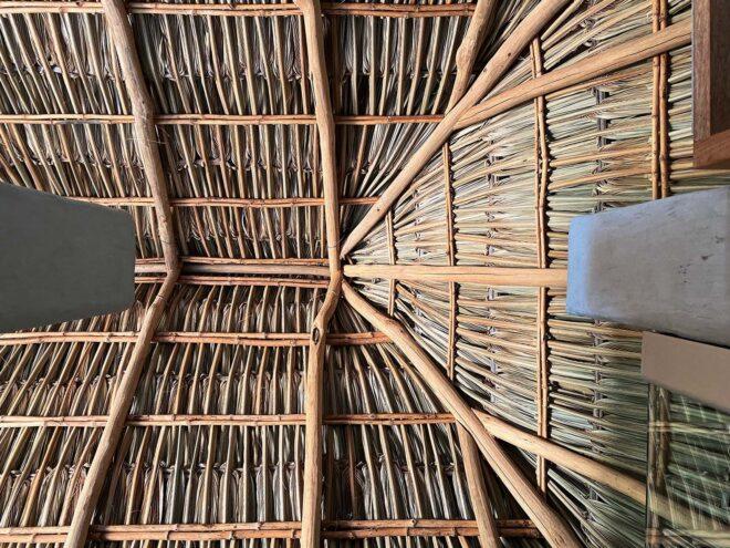 the interior of a pitched roof made with light-colored wood.