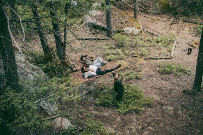 people lounging on woven hammock