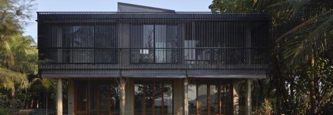 rectangular black home on stilts