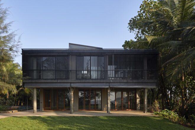 rectangular black home on stilts