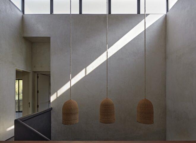 three hanging lights against a gray wall