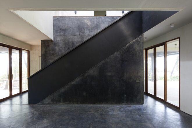 black staircase under a skylight