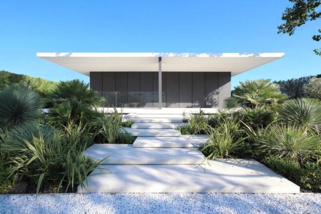 path leading to white and gray beach villa