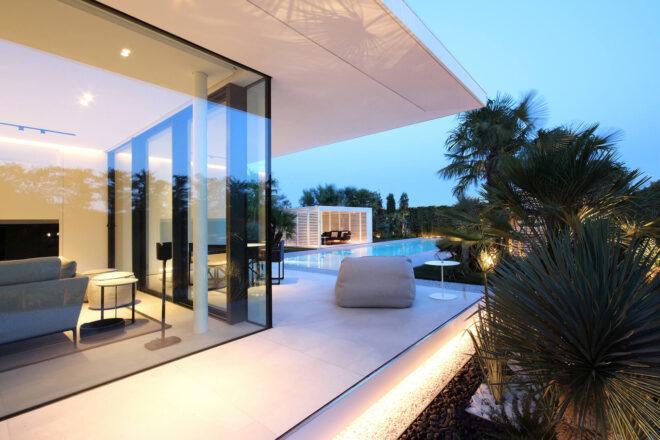 villa with glass walls and extended roof eaves