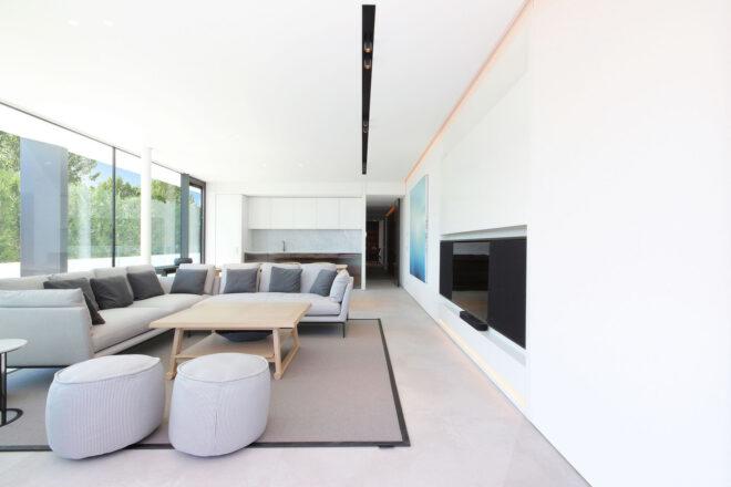 white room with gray sofa and wood coffee table